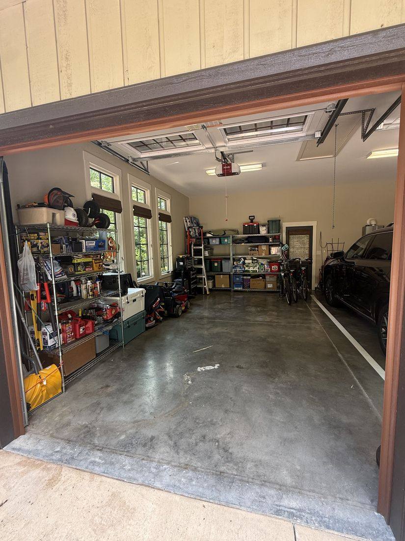 The same garage after the transformation — clean floor, organized shelves, room for the car