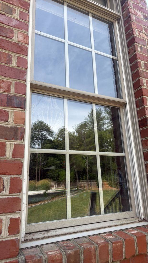 Window before cleaning — grime on the glass, frame and sill